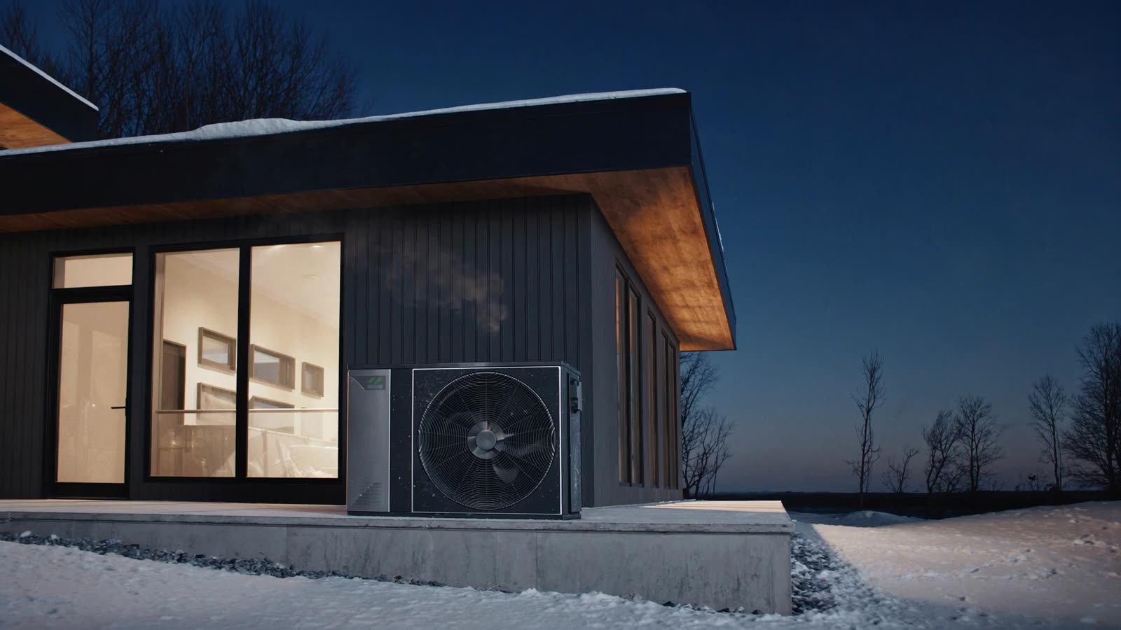 Cold-climate heat pump running beside a modern Manitoba home on a winter evening